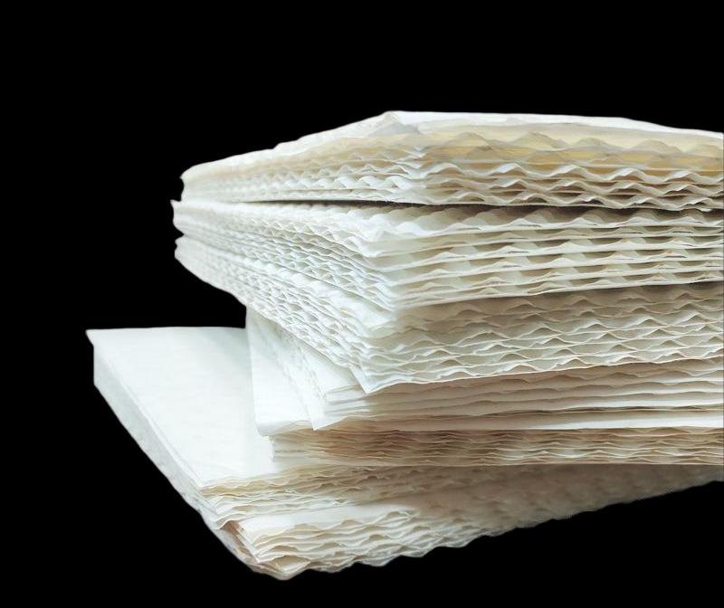 Stacked embossed paper board